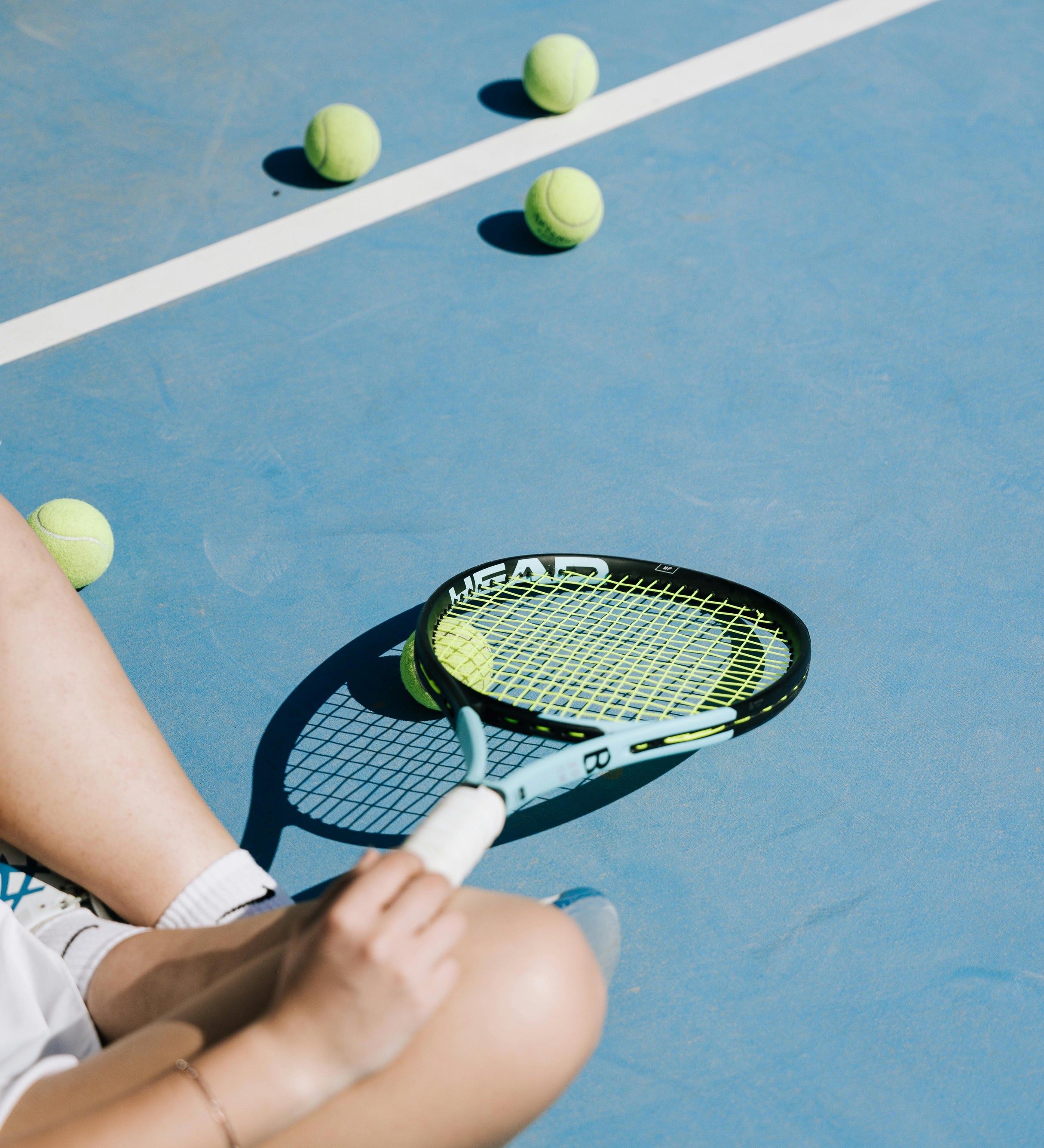 Athlete resting after a tennis match, enjoying a nuwave naturals protein shake