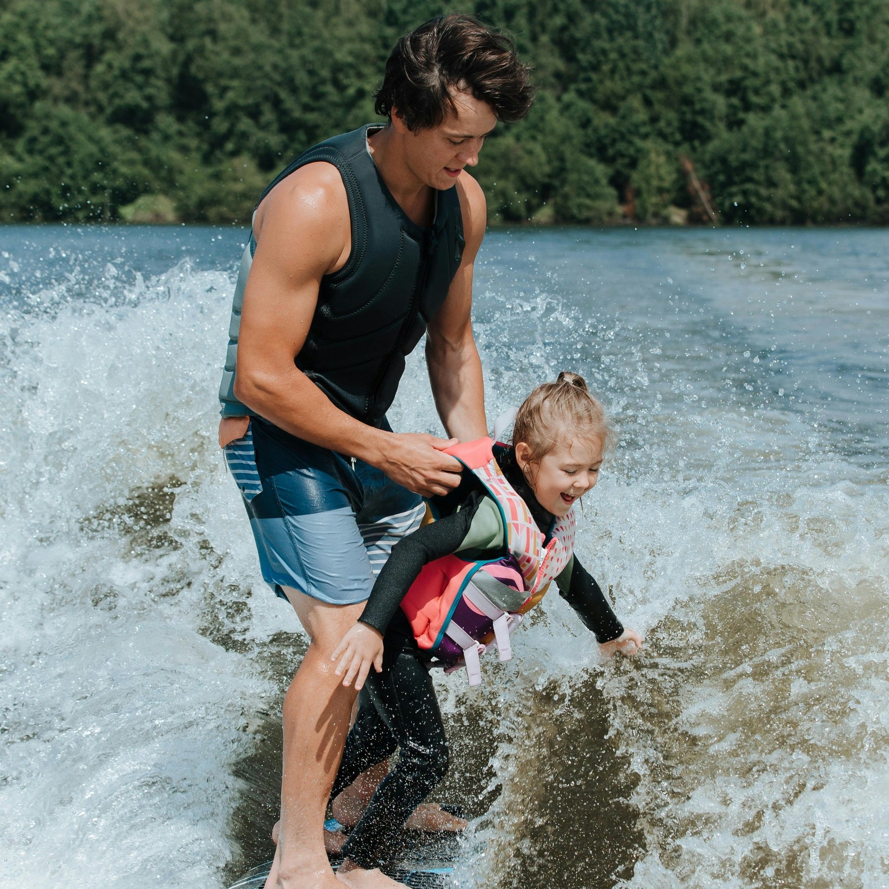 Man surfing with daughter showing the active outdoorsy lifestyle that nuwave products support