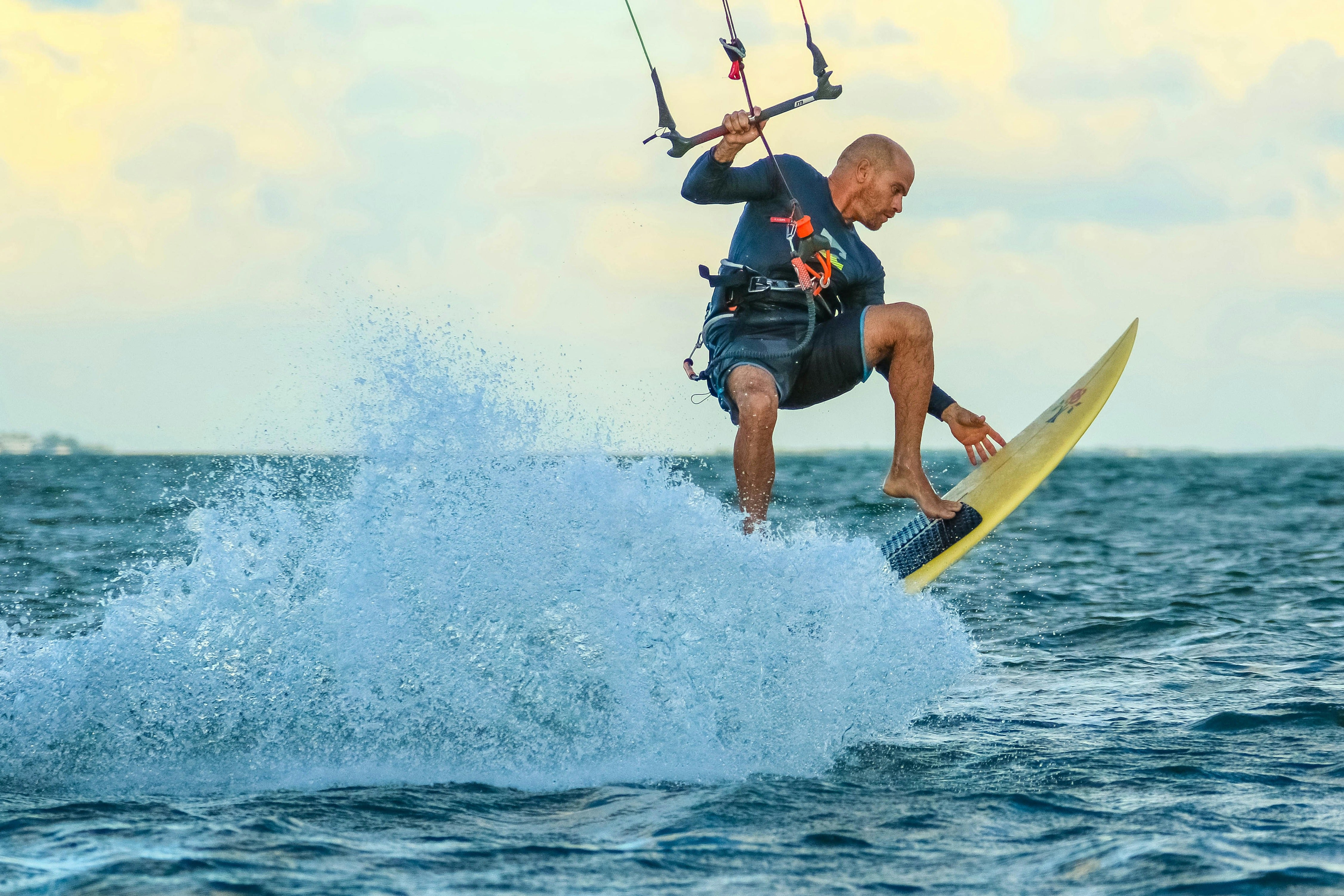 Man surfing on the open water leading an active lifestyle supported by nuwave protein