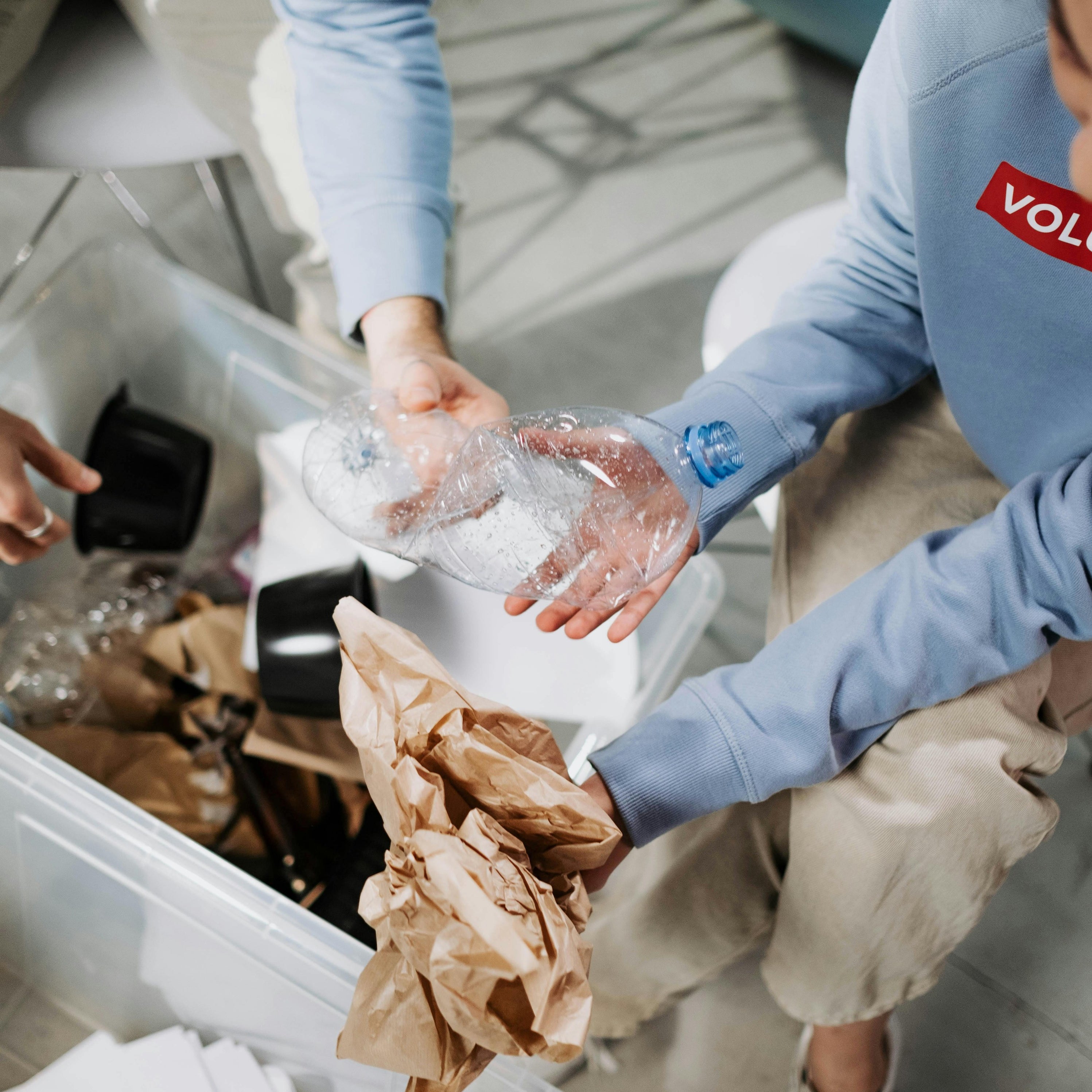 Two volunteers sorting trash and recyclables showing nuwave's commitment to sustainability 