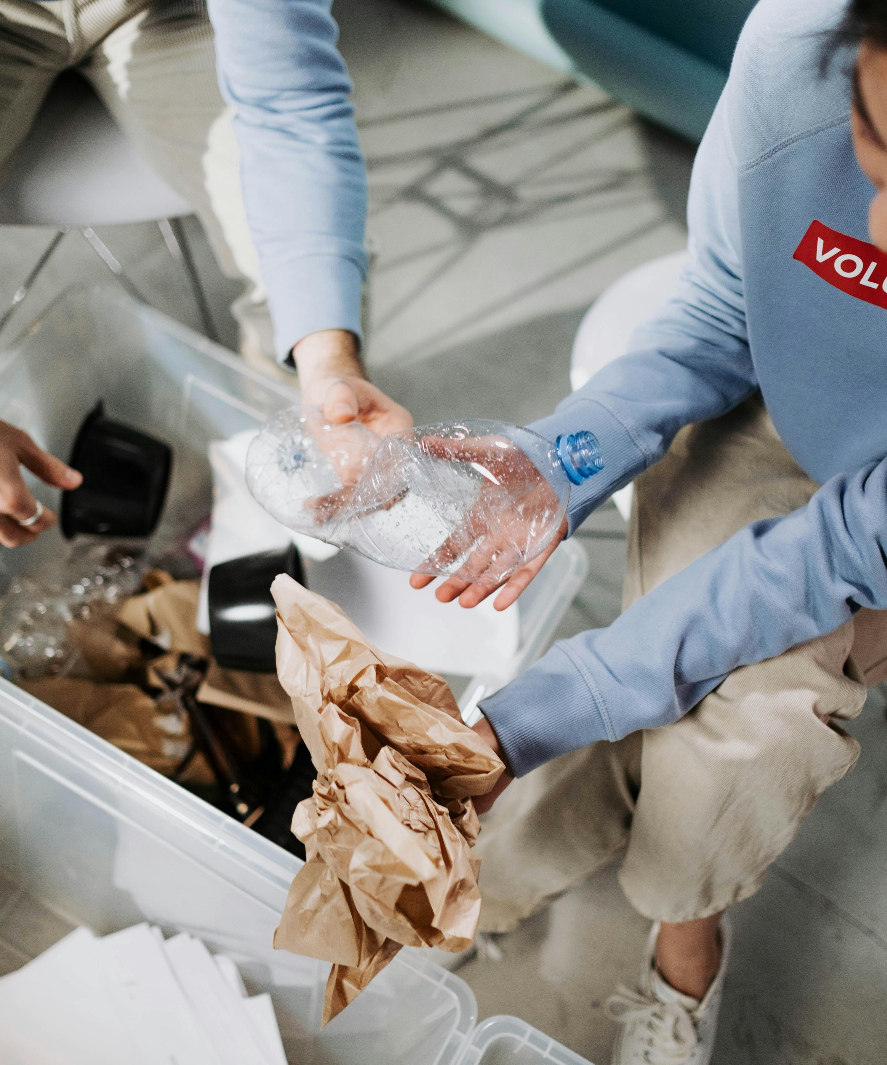Two volunteers sorting trash and recyclables showing nuwave's commitment to sustainability 