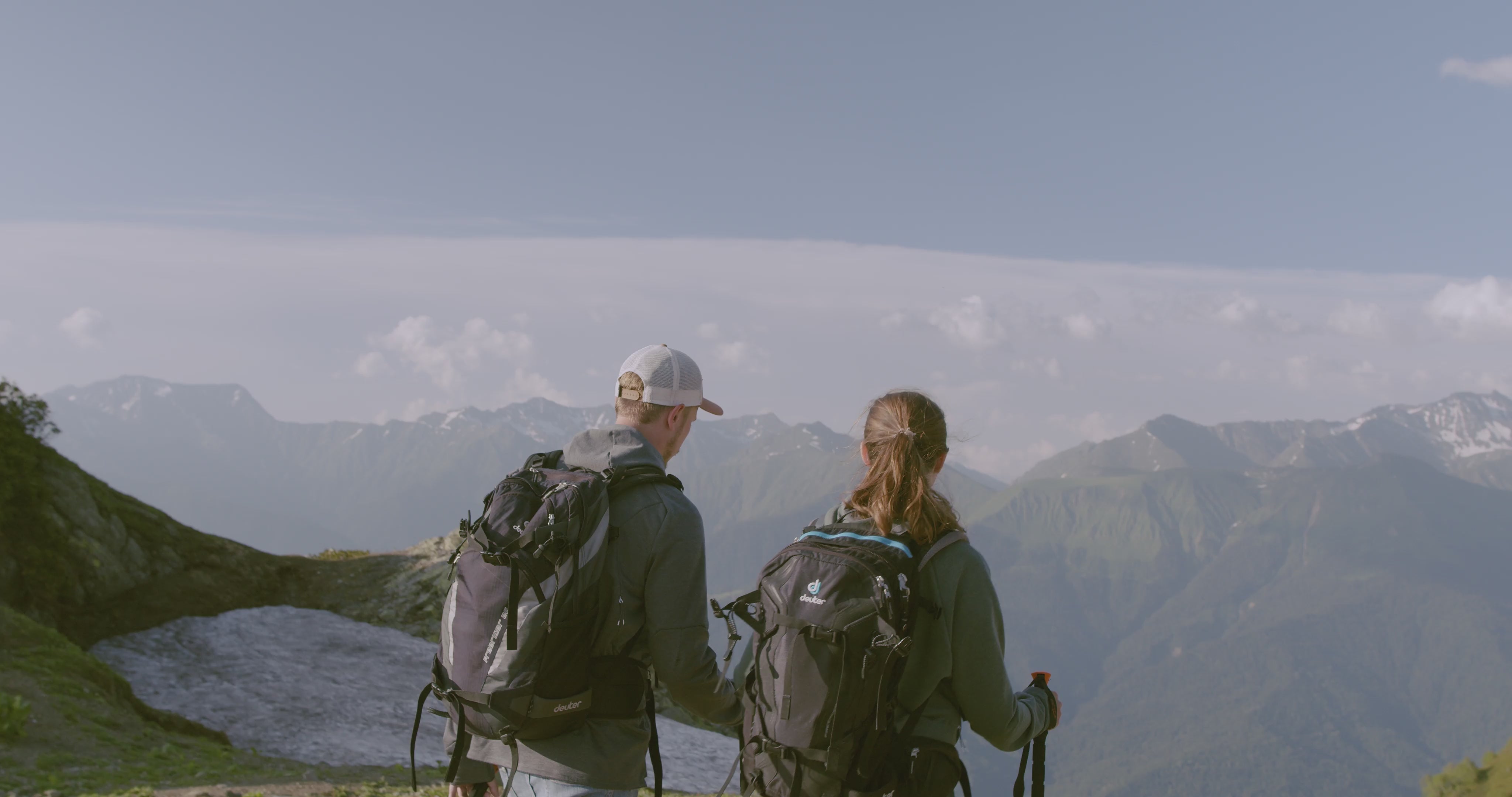 Man and woman hiking a mountain range before ejoying a nuwave protein shake to support their active lifestyle