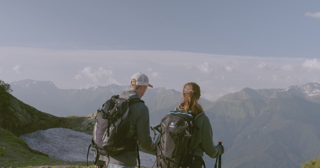 Man and woman hiking a mountain range before ejoying a nuwave protein shake to support their active lifestyle